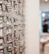 A selective focus shot of a row of glasses on display at an optics store